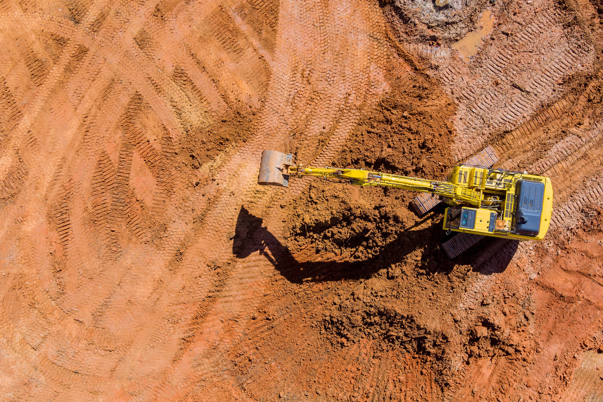 Excavator undertaking civil earthworks on a large construction site