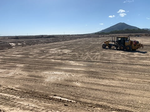 Motor grader working across a large civil earthworks project in central Queensland